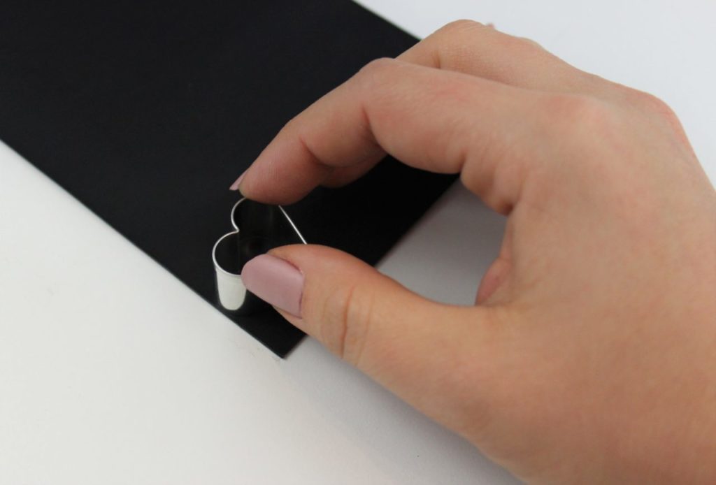 Die Herzen für das Kleeblatt werden mit Hilfe einer Ausstechform aus der Wachsplatte gestochen.